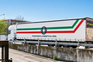 Camion in movimento su strada per trasporto diretto di merci.